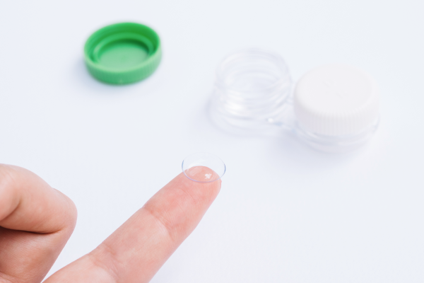 index finger holding a contact lens